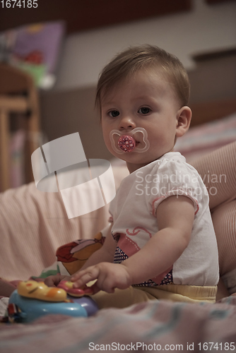 Image of cute little one year old baby and making first steps