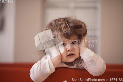 Image of little baby girl with strange hairstyle and curlers