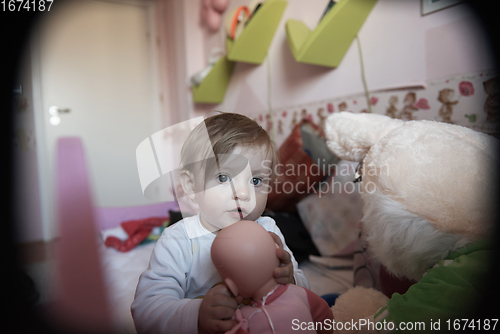 Image of cute little one year old baby and making first steps