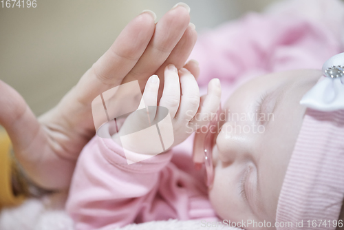 Image of mother is playing with baby at home