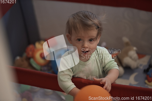 Image of cute little baby playing in mobile bed