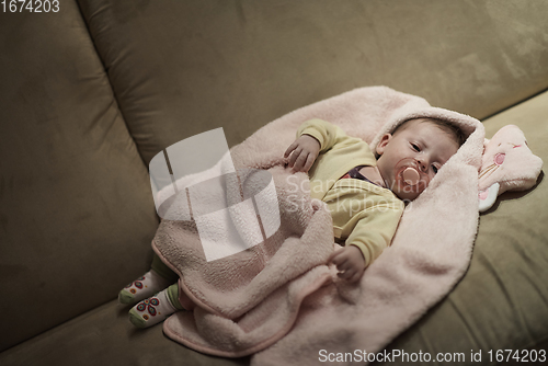 Image of newborn baby sleeping at home in bed