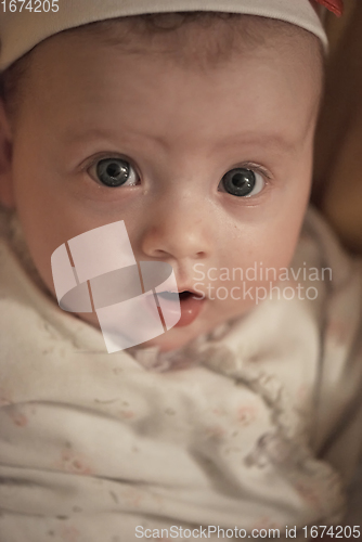 Image of portrait of happy newborn little baby smilling