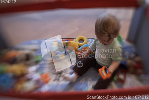Image of cute little baby playing in mobile bed