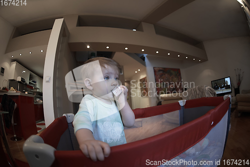 Image of cute little baby playing in mobile bed