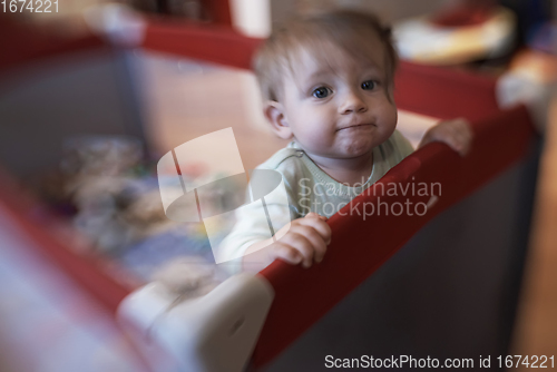 Image of cute little baby playing in mobile bed