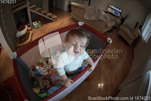 Image of cute little baby playing in mobile bed