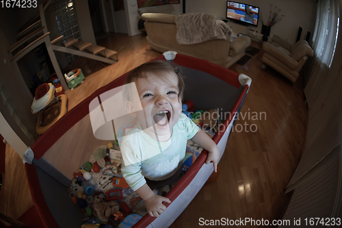 Image of cute little baby playing in mobile bed