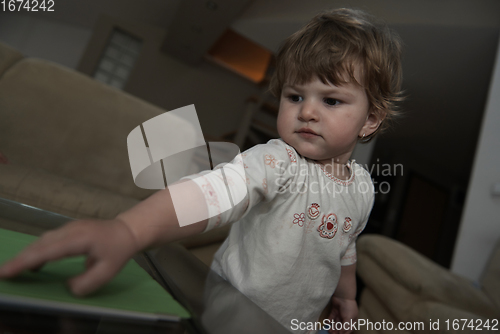 Image of Adorable cute beautiful little baby girl playing with toys at home