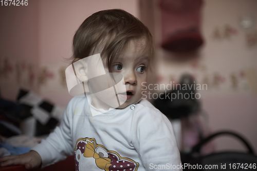 Image of cute little one year old baby and making first steps