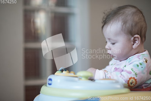 Image of baby learning to walk in walker