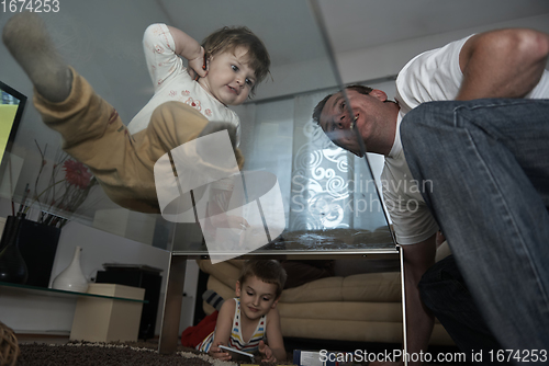 Image of Little child playing with sister at home