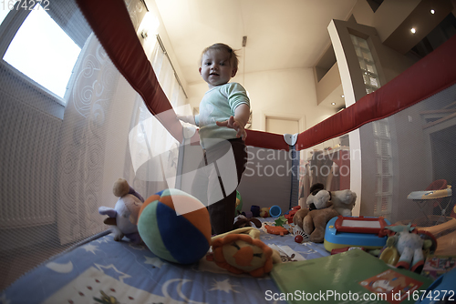 Image of cute little baby playing in mobile bed