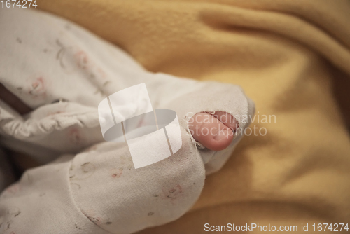 Image of One month newborn baby sleeping in bed