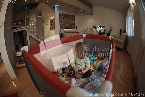 Image of cute little baby playing in mobile bed