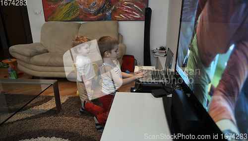 Image of Little child playing with sister at home