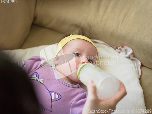 Image of baby eating milk from bottle