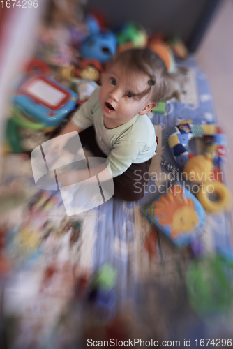 Image of cute little baby playing in mobile bed