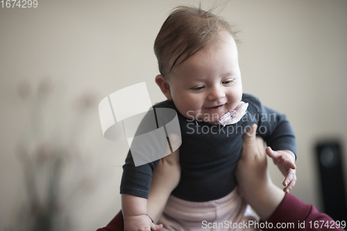 Image of mother is playing with baby at home