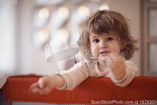 Image of little baby girl with strange hairstyle and curlers