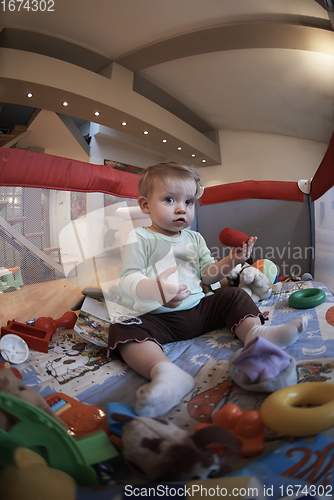 Image of cute little baby playing in mobile bed