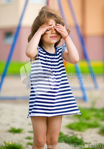 Image of Cute little girl is playing in playground