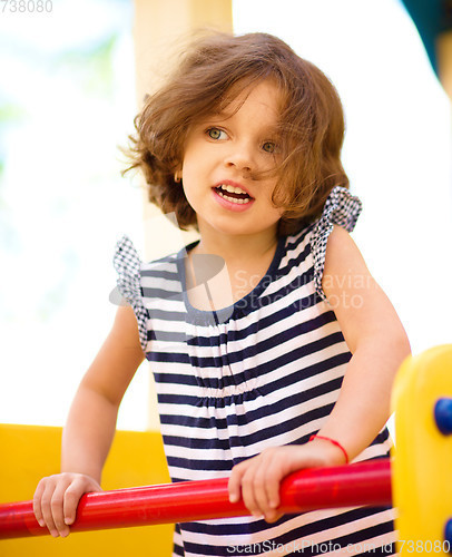 Image of Cute little girl is playing in playground