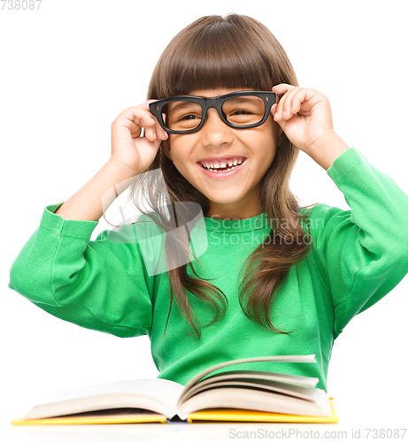 Image of Little girl is reading a book