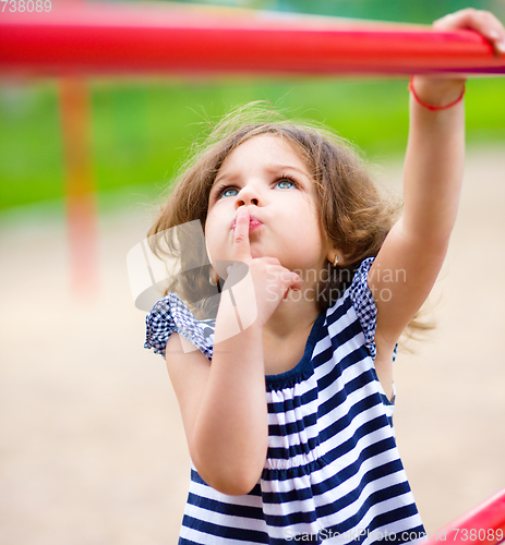 Image of Cute little girl is playing in playground