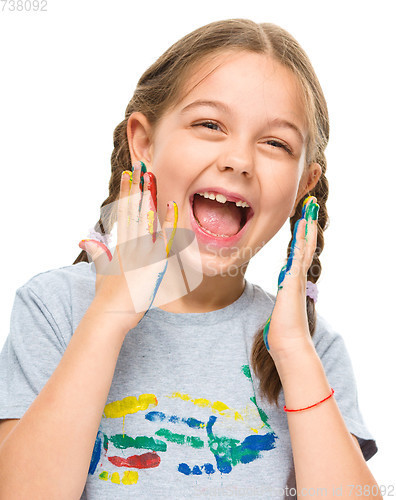 Image of Portrait of a cute girl playing with paints