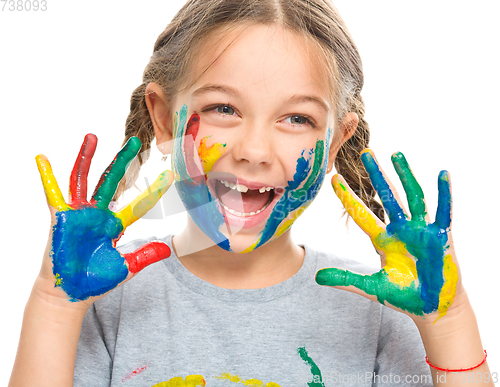Image of Portrait of a cute girl playing with paints