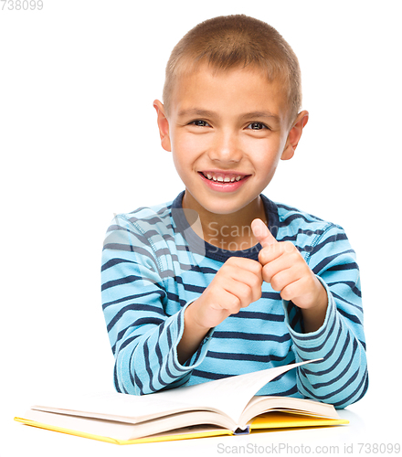 Image of Little boy is reading a book