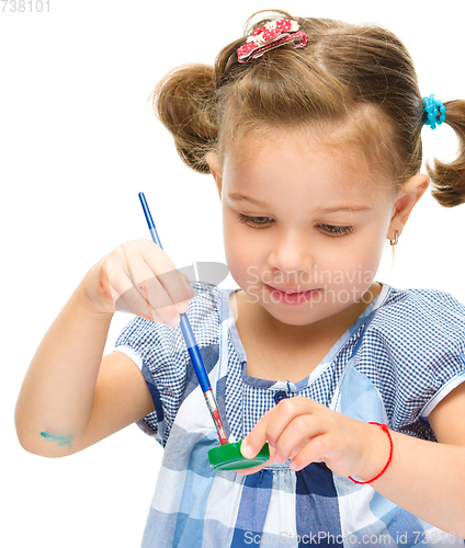 Image of Little girl is painting with gouache