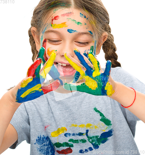 Image of Portrait of a cute girl playing with paints
