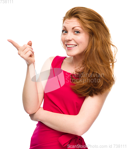 Image of Portrait of a young woman pointing to the left