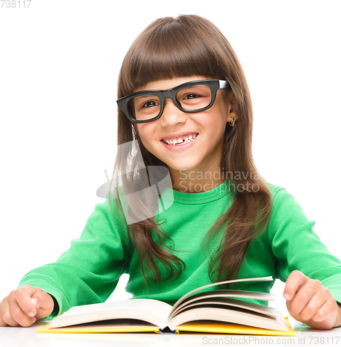 Image of Little girl is reading a book