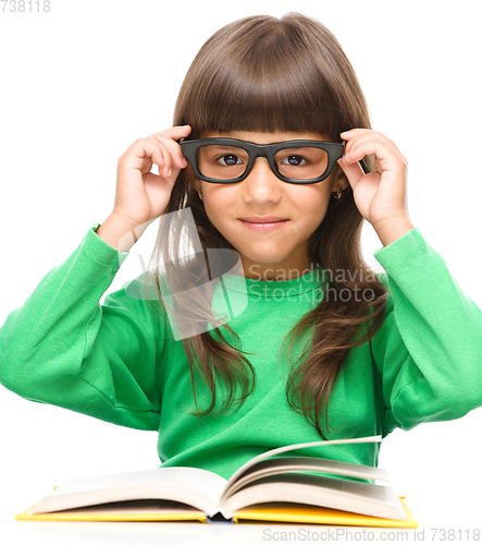 Image of Little girl is reading a book