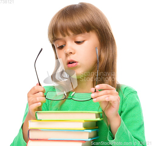 Image of Cute little girl is wearing glasses