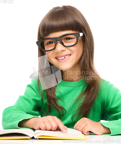 Image of Little girl is reading a book