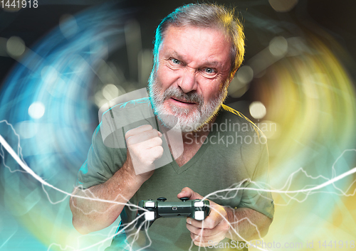 Image of Enthusiastic gamer. Joyful man holding a video game controller