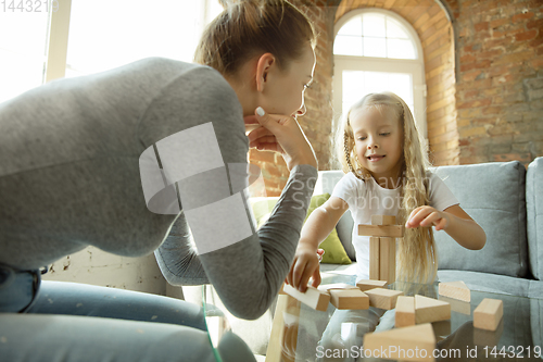 Image of Teacher and little girl, or mom and daughter. Homeschooling concept