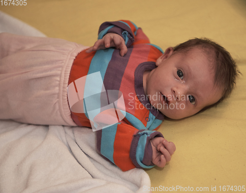 Image of One month newborn baby sleeping in bed