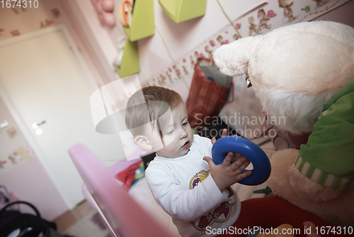 Image of cute little one year old baby and making first steps