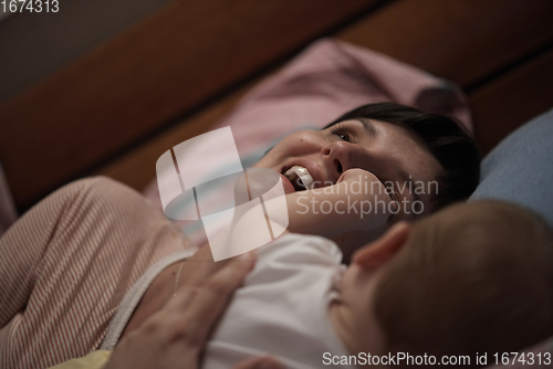 Image of mother is playing with baby at home