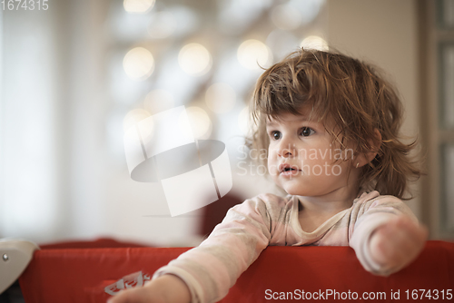 Image of little baby girl with strange hairstyle and curlers