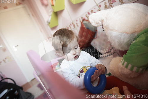 Image of cute little one year old baby and making first steps