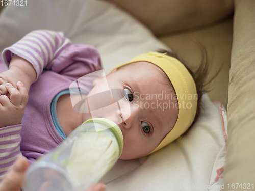 Image of baby eating milk from bottle