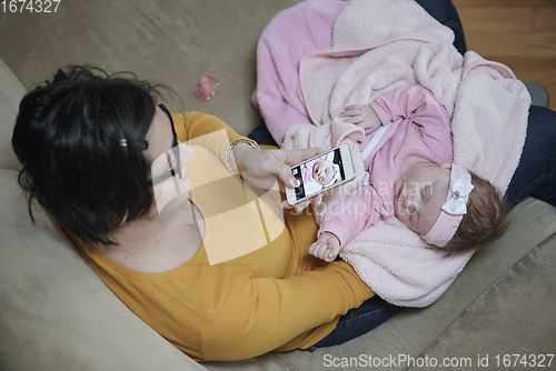 Image of mother is playing with baby at home