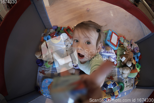 Image of cute little baby playing in mobile bed