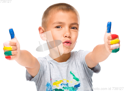 Image of Portrait of a cute boy playing with paints